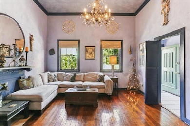 Hardwood floors and high ceilings in the living room. Front entrance and foyer on the right