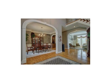 Beautiful archways define the living and dining ro