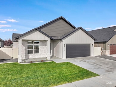 Modern farmhouse featuring stone siding, concrete driveway, board and batten siding, an attached garage, and roof with shingles