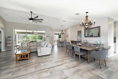 Dining area featuring a chandelier and vaulted ceiling