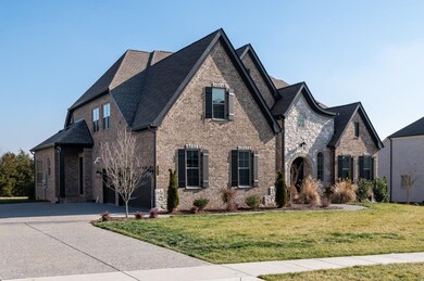 3 Car side entry garage with a separate friends entrance. Parking pad extension to accommodate all of the family's cars. 