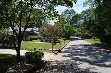 View of asphalt road featuring curbs