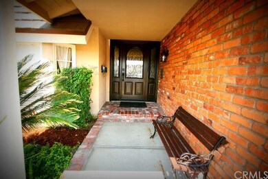 Enter home through gorgeous dark stained door with