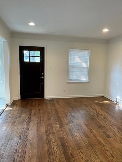 Entrance foyer with recessed lighting and dark wood-style flooring