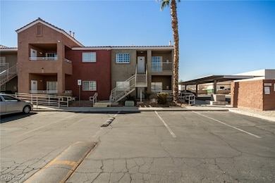 View of property featuring uncovered parking