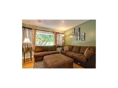 Large picture window floods the living room with n