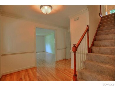 Foyer with refinished hardwood floors.
