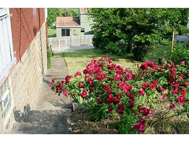 Exterior Front. BEAUTIFUL ROSE BUSHES ADD COLOR TO