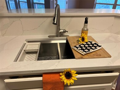 Room details with light stone counters and a sink