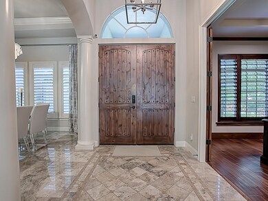 Grand Foyer with wood doors, Den to the Right and 