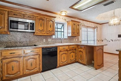 Kitchen featuring a wealth of natural light, black