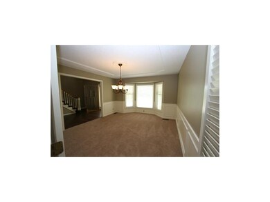 Formal dining rm boasts new carpet, wainscotting, 