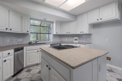Kitchen with light tile patterned floors, white c
