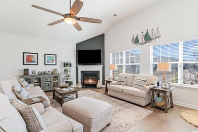 Living room featuring lofted ceiling, ceiling fan,