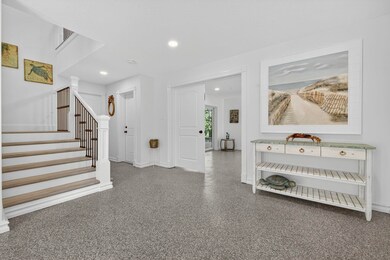 Entrance foyer featuring stairs, speckled floor, and recessed lighting