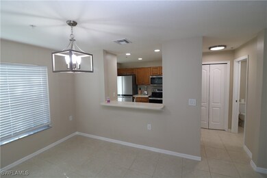 Kitchen with hanging light fixtures, a notable cha