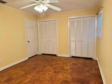 Unfurnished bedroom featuring ceiling fan, crown m