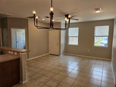 Unfurnished room featuring light tile patterned f