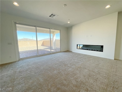 Unfurnished living room featuring carpet, a glass