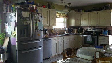 Large eat in kitchen with ceramic flooring.
