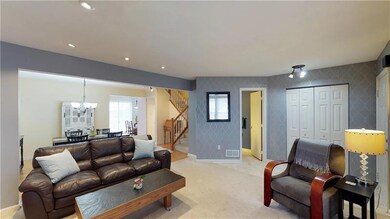 Living room features neutral colors, recessed ligh