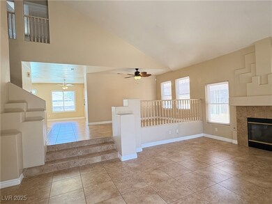 Unfurnished living room featuring ceiling fan, hig