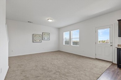 Carpeted foyer featuring baseboards