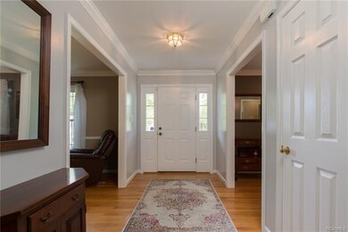 Lovely foyer with double sidelights, fresh grey pa