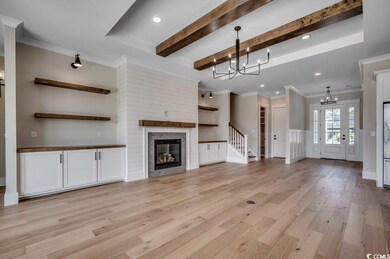 Unfurnished living room featuring a chandelier, li