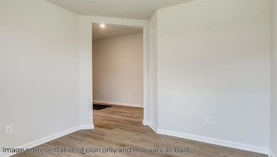 Unfurnished room featuring baseboards and light wood-style floors
