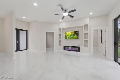 Unfurnished living room with marble tiled floors,