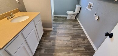 Bathroom with vanity, toilet, and hardwood / wood-