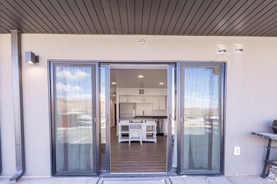 Property entrance featuring stucco siding and a sink