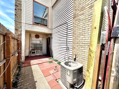 View of exterior entry featuring central AC and fe