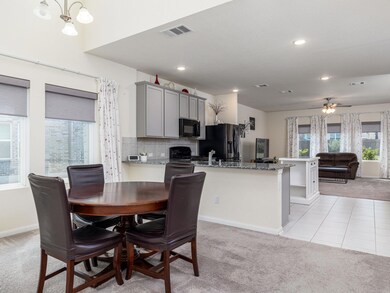 Dining area with light colored carpet, baseboards