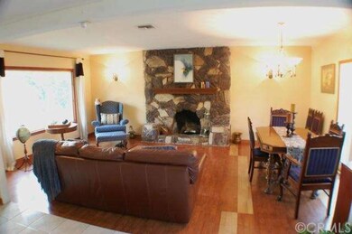 Living room, dining area, rock fireplace, large pi