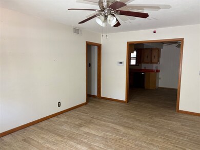 Empty room featuring light wood-style flooring and ceiling fan