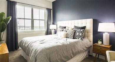 Bedroom featuring dark carpet