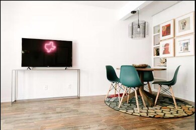 Dining area featuring wood finished floors and ba