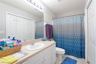 Full bath with vanity, toilet, and tile patterned