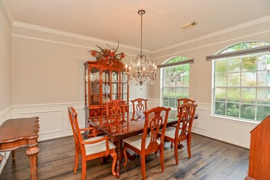The dining room also has hardwood floors and big windows overlooking the front yard