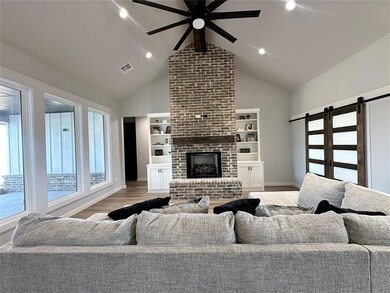 Living room featuring a barn door, plenty of natur