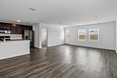 Unfurnished living room featuring visible vents, b