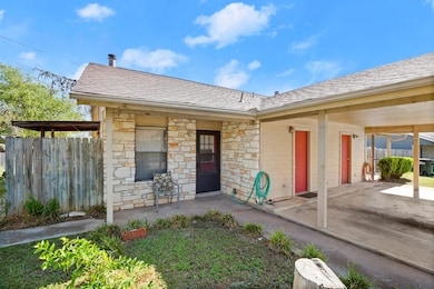 Doorway to property with fence, a shingled roof, 