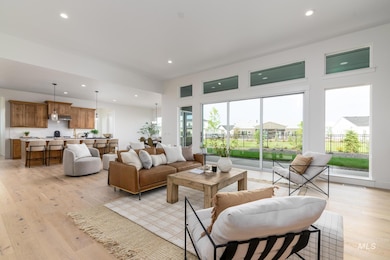 Living area with light wood-style flooring and recessed lighting