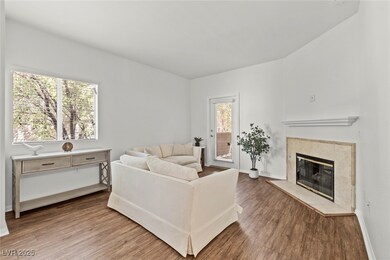Living room with baseboards, wood finished floors,