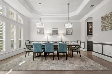 Formal dining room for all your special occasions with triple arch topped windows and plantation shutters