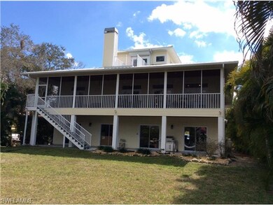 REAR OF HOUSE SHOWING GARAGE LEVEL PATIO, MAIN LEV