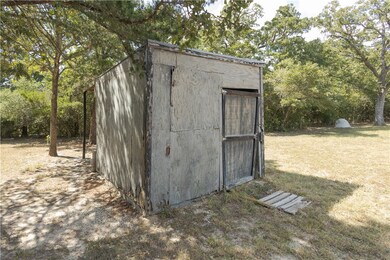 View of outdoor structure with a lawn