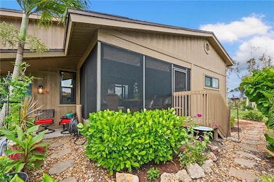 View of side of property with a patio and a sunroo